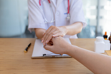 Doctor shook hands to encourage the patient after informing the results of the examination and informing the patients about treatment guidelines and prescribing medicines. Disease examination concept.