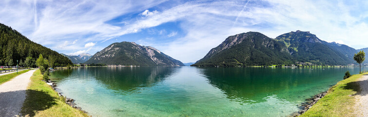 Fototapeta na wymiar Panoramic View of Lake Achen during Summer Day in Tyrol. Beautiful Scene of Achensee with Mountains in Austria.