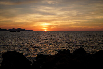 Fototapeta premium Cala Viola de Ponent, Menorca. September 2021. Magnificent sunset in the Mediterranean Sea. On one of the paradisaical beaches of the island of Menorca.