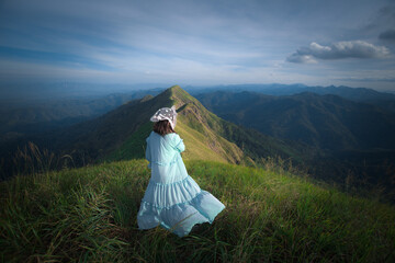happy hiking woman on top of mountain at Khao Chang Puak, Thongphaphum National Park, Kanchanaburi...