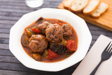 Fototapeta na wymiar cooked meatballs with stewed eggplant in bowl