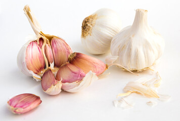 garlic heads and cloves on white background