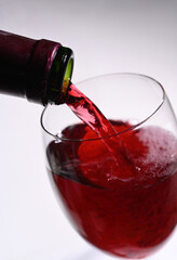 red wine pouring into glass closeup