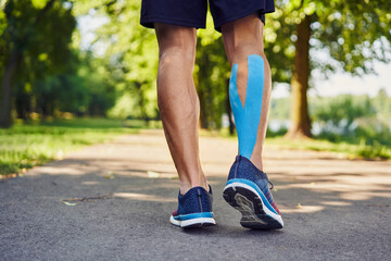 Kinesiology runner with a taped calf. Runner's injuries concept