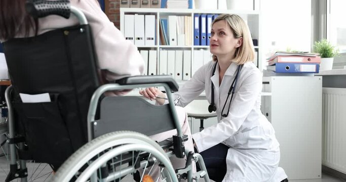 Doctor neurologist checking knee reflexes with percussion hammer to disabled woman in wheelchair 4k movie slow motion