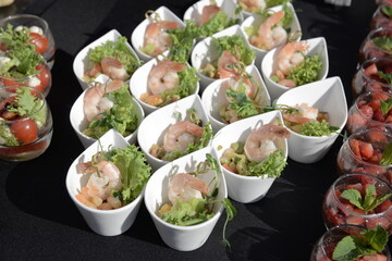 appetizer of cucumber with shrimp and cream cheese, small portion. closeup on a white plate. horizontal