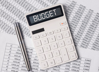 Budget word on calculator with paper documents.