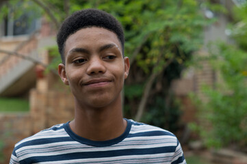 Close up portrait of happy teenager standing outdoors
