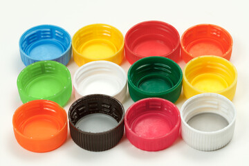 Closeup of plastic bottle caps on white background