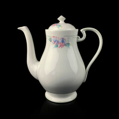 antique crockery for table setting. vintage porcelain teapot with floral pattern on black isolated background