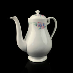 antique crockery for table setting. vintage porcelain teapot with floral pattern on black isolated background