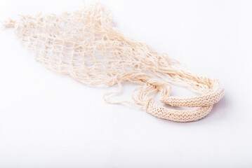 Eco friendly string bag on white background, responsible consumption. Ecological concept. Caring for the environment