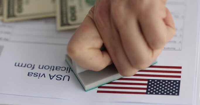 Hand putting stamp approved on documents for obtaining american visa closeup 4k movie