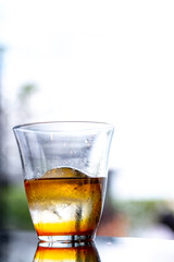 Iced Americano coffee in glass cup on glass table with outdoor background
