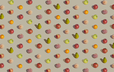Creative pattern made with fresh variety fruits against pastel beige background. Minimal summer layout.