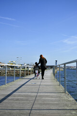 Mother and daugher walking near the beach. 
