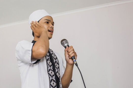 Religious Muslim man doing the call to prayer