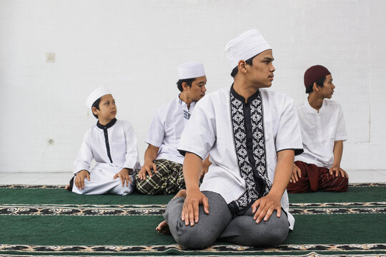 A group of Muslim men salat with performing congregational prayers movement