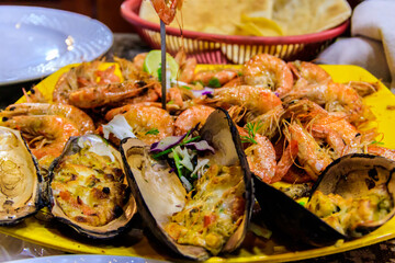 Tasty prawns and mussels in plate in restaurant