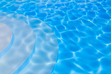Fototapeta na wymiar Texture of water in swimming pool for background. Surface of blue swimming pool