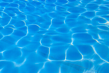 Texture of water in swimming pool for background. Surface of blue swimming pool