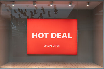 hot deal - red banner in the window window of a supermarket boutique store text in white letters