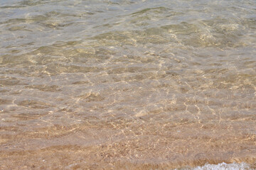 Waves on the surface of the turquoise tropical sea.