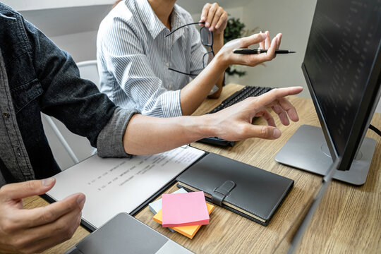 Programmer Team of  Developing programming and website working in a software develop company office, writing codes and typing data code, Programming with HTML, PHP and javascript