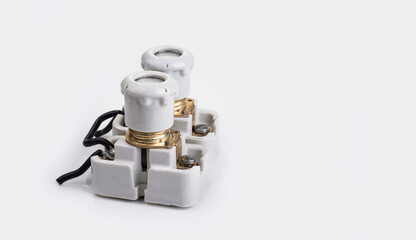 Old porcelain fuse with a holder on a white background