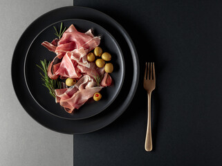 Prosciutto with rosemary and green olives.