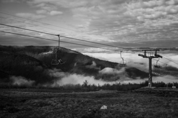 A ski lift is a mechanism for transporting skiers up a hill. Ski lifts are typically a paid service at ski resorts. Beautiful view from the mountain top