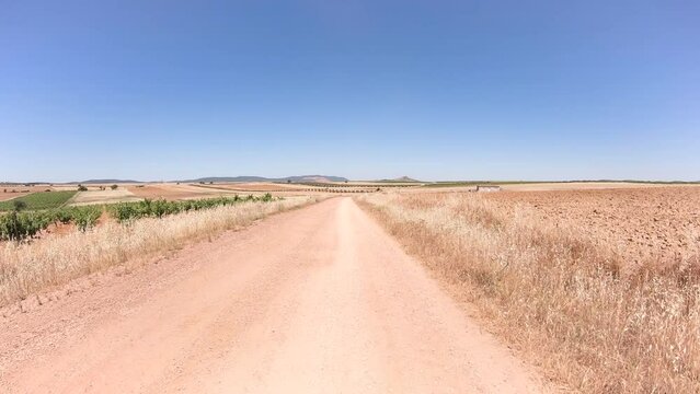 Via de la Plata, dirt road through agricultural plowed fields before arriving to Puebla de Sancho Perez, province of Badajoz, Extremadura, Spain - dolly forward