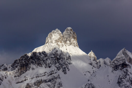 The 'Bischofsm&uuml;tze' mountain peak covered in snow with the top lit by sunlight