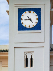 Fototapeta na wymiar Close-up photo of the railway station's clock tower in Asilah, Morocco