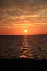 Fototapeta na wymiar 夕日に照らされた海の写真素材
