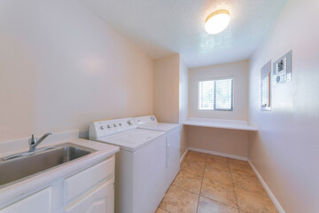 Laundry room interior with vanity and stainless steel sink