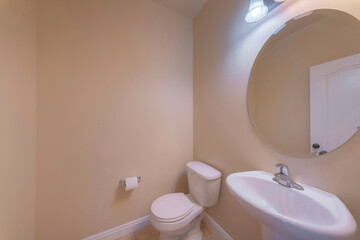 Small bathroom interior with beige walls and pedestal sink