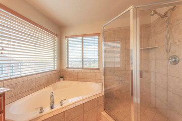 Corner bathtub and shower stall with ceramic tiles surround