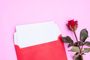 Red envelope with white greeting card and red rose