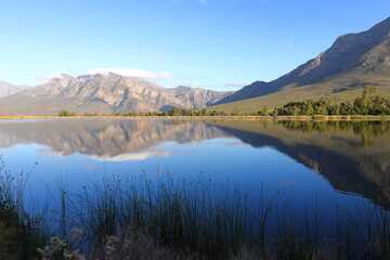 Fototapeta na wymiar Mountains reflected in a farm dam near Worcester, South Africa.