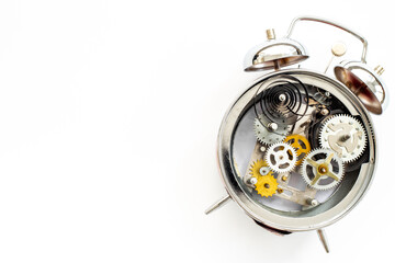 Open alarm clock with metal steel gears and wheels closeup