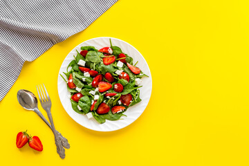 Spinach salad with strawberry and goat cheese, top view