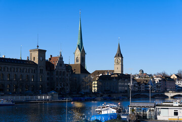 Fototapeta premium Church tower of medieval protestant churches Women's minster and St. Peter at the old town of Zürich on a sunny winter day. Photo taken February 5th, 2022, Zurich, Switzerland.