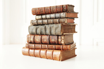 stack of unique antique books isolated on white.