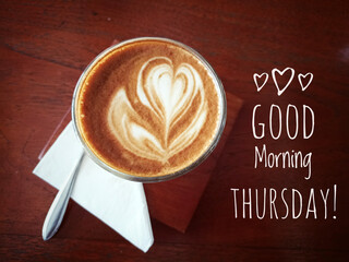 Thursday concept with morning coffee late in a cup on brown wooden table. Good morning Thursday. Happy Thursday and be productive.