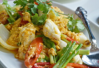 stir fried crab meat in yellow curry and egg on plate