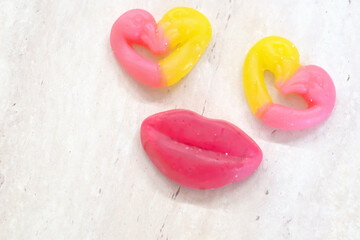 Red and yellow marmalade in the shape of a heart, highlighted on a light background.