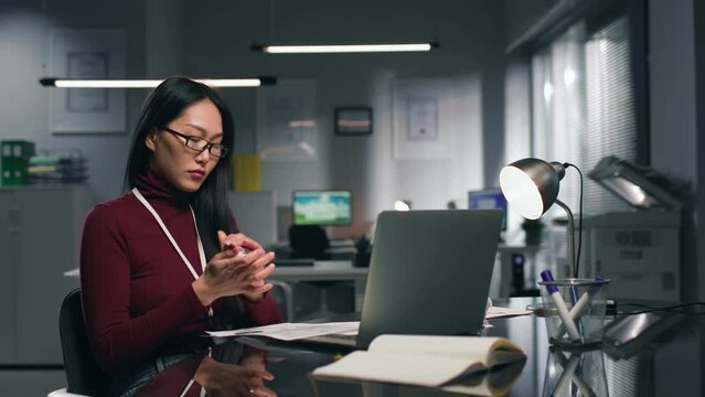 Stressed asian businesswoman crumple documents and throw away. 