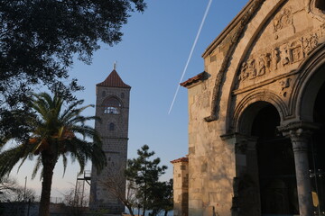 Hagia sophia mosque in Trabzon, sky and tower background, traces of plane on sky.