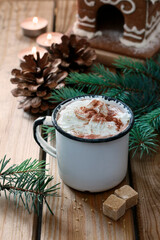 Hot chocolate in vintage mug on wooden table.